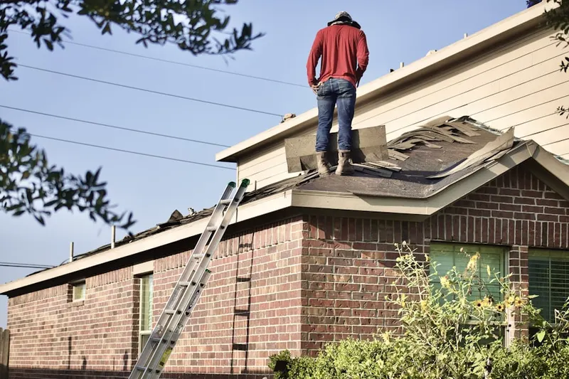Professional roofer working on a residential roof in Pullentown